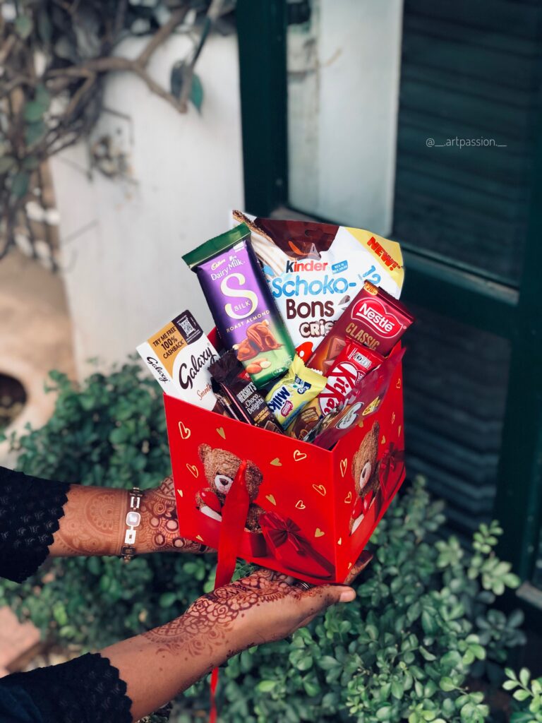 a red teddy bear box with overloaded chocolates