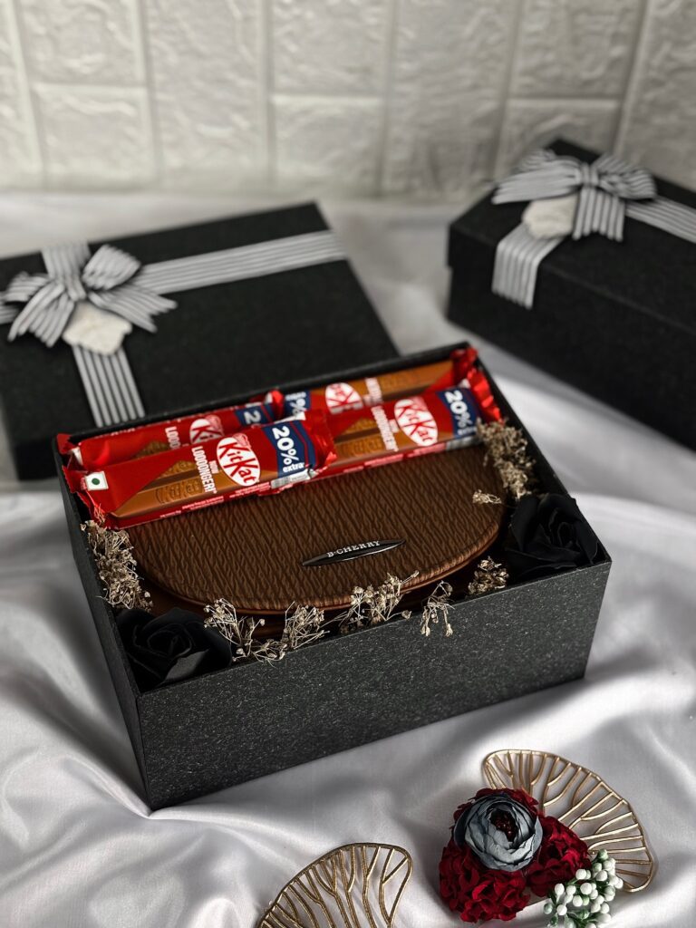 black elegant box with a stylish side bag and chocolates