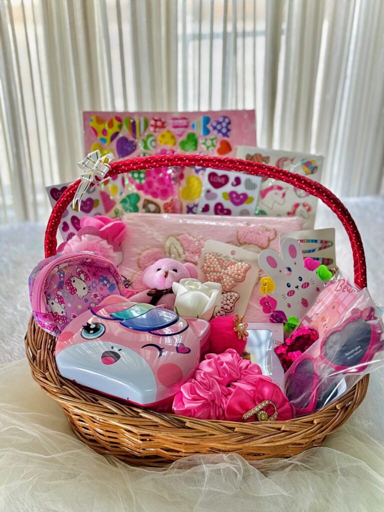 Baby gift basket with pink toys, baby care products, and a cute items for lovely girls