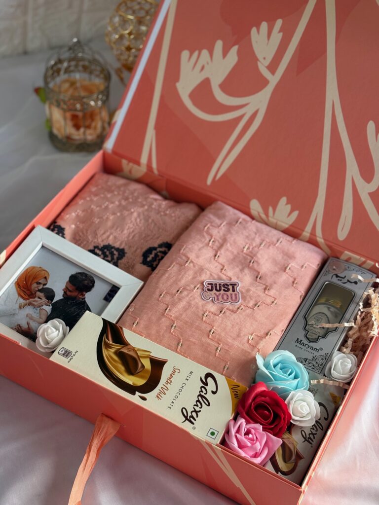peach themed girlish luxury themed hamper with dress, frame, chocolates, flowers and perfume