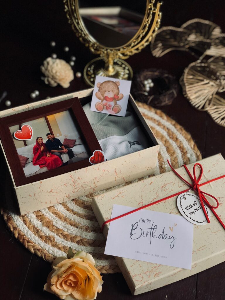 a cream colour cute little box with tshirt and frame